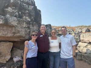 Group of people standing by rocky landscape