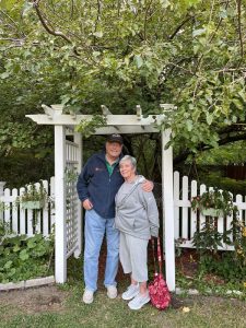 Couple standing under garden arch