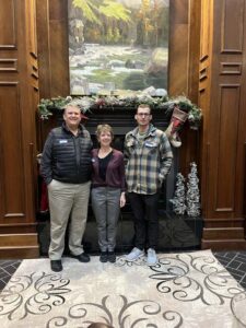 People standing in front of fireplace